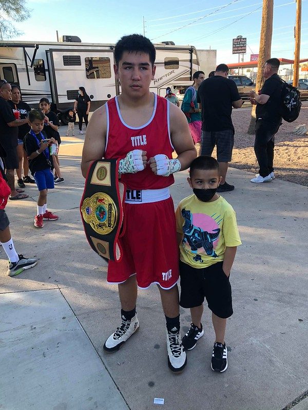Old School Boxing Club young amateur fighter with a championship belt