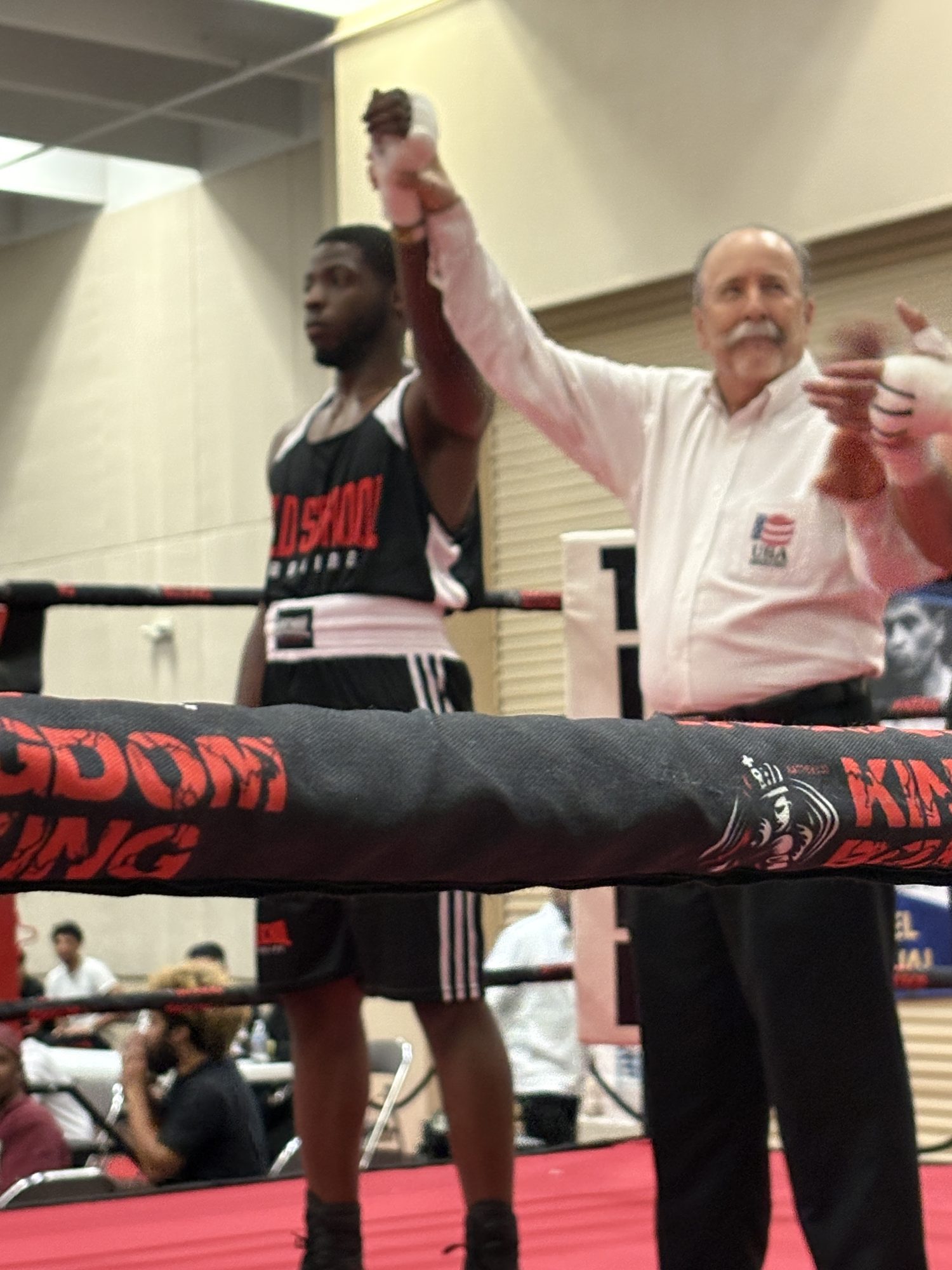 Old School Boxing Club amateur fighter with hand raised in victory