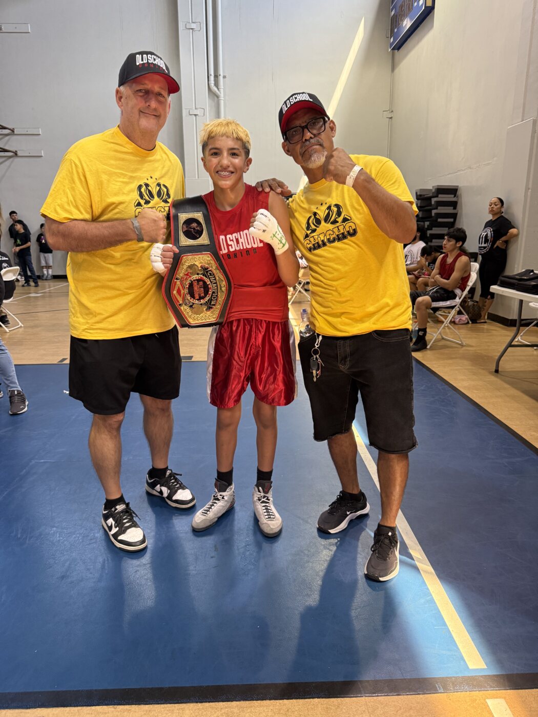 Chicho Rodriguez with two Old School Boxing coaches and his championship belt