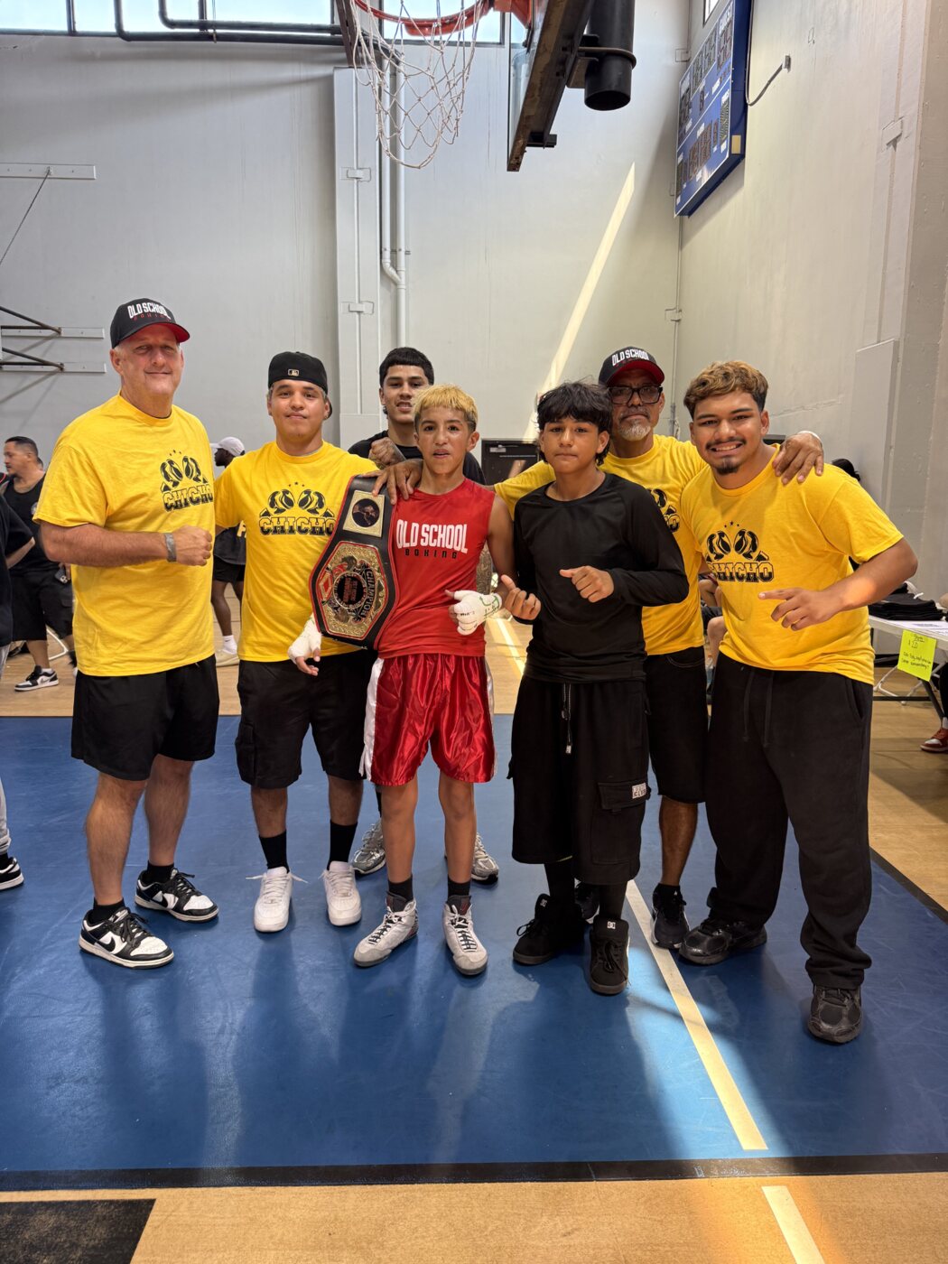 Chicho Rodriguez celebrating with members of the Old School Boxing team