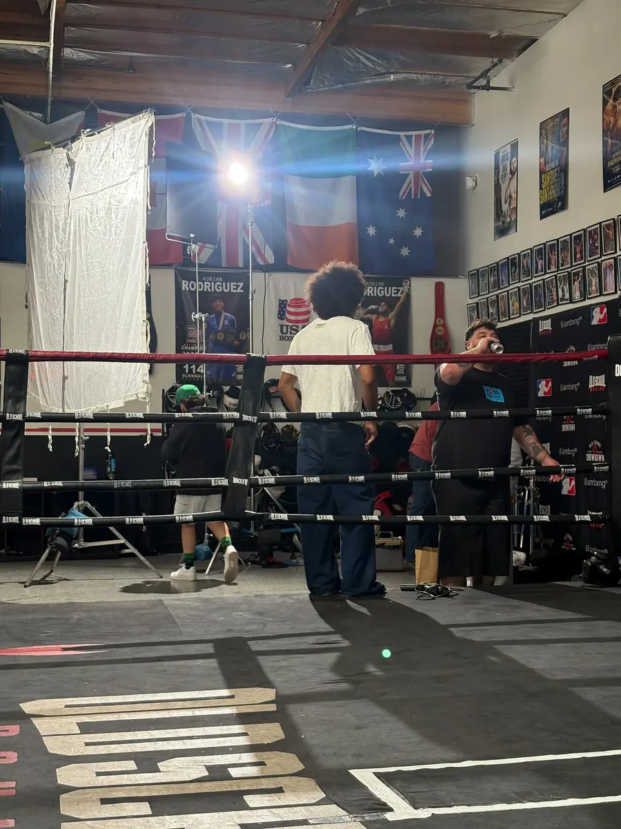 Production lighting and crew set up around the boxing ring